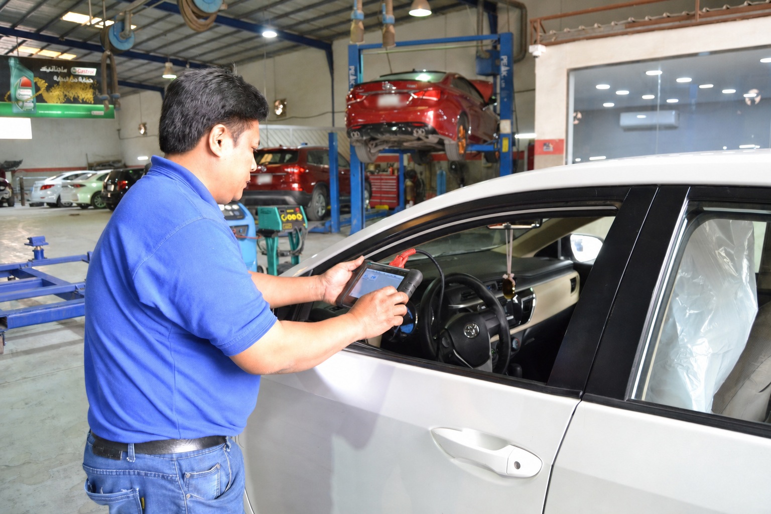 Technician using diagnostic equipment inside the workshop